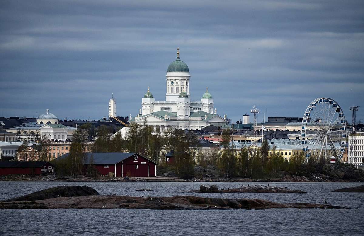Helsinki Cathedral and the waterfront skyline seen across the sea from the islands