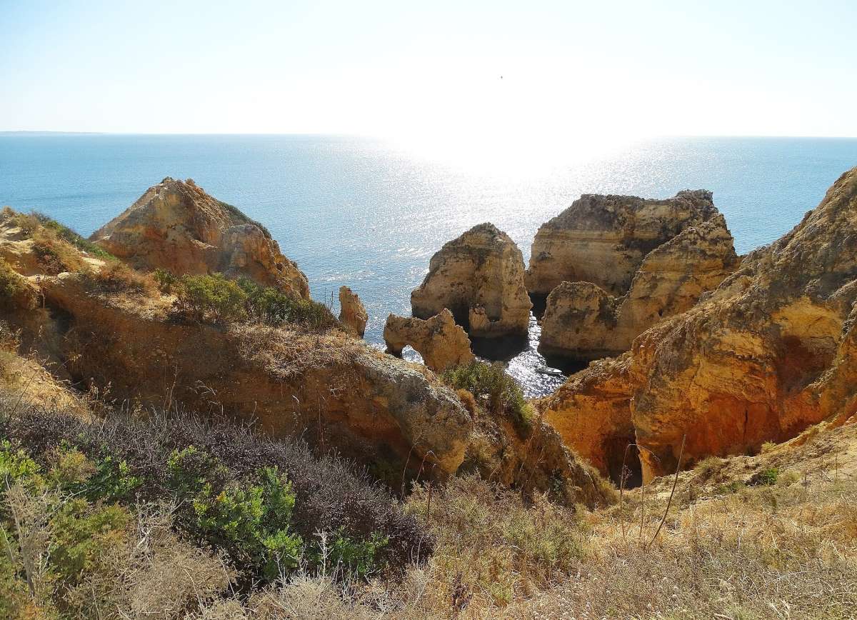 Golden sandstone cliffs and sea stacks at Ponta da Piedade near Lagos, above the Atlantic